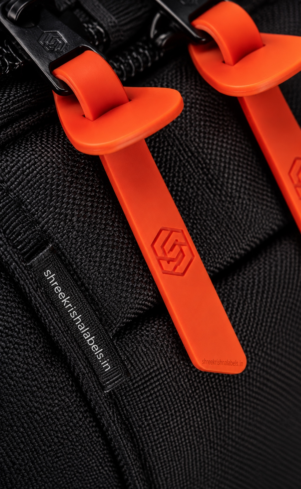 Orange TPU rubber zipper pull labels on bag
