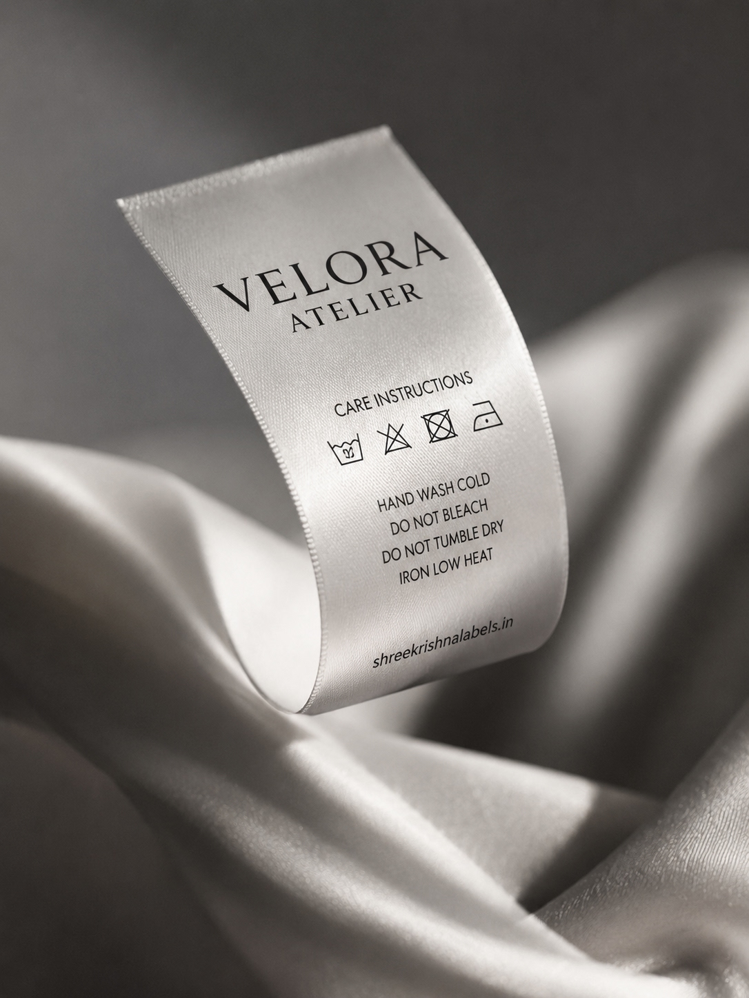 VELORA satin wash care label draped on silk